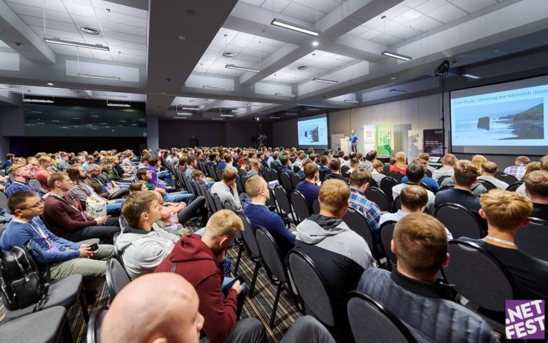 Eran Stiller speaking in-front of a packed audience